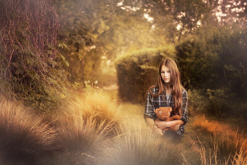 Girl Holding Teddy Bear — Brown, Serene, Sunset