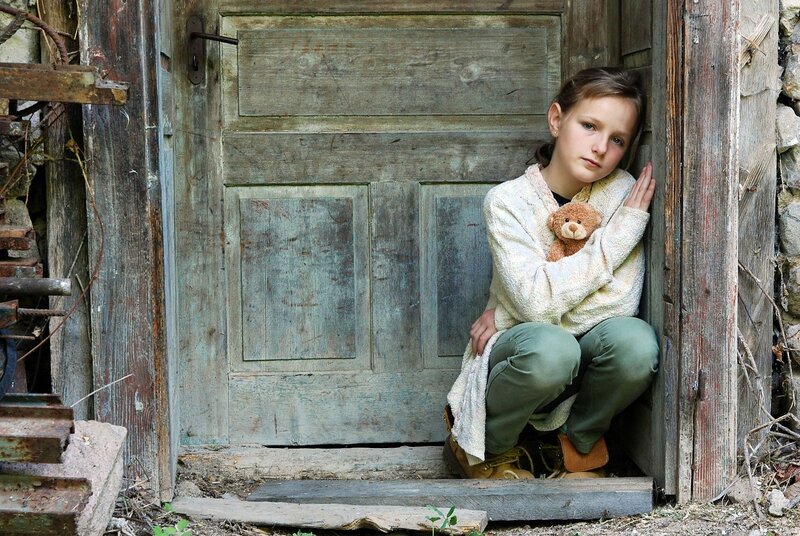 Girl Holding Teddy Bear — Brown, Somber