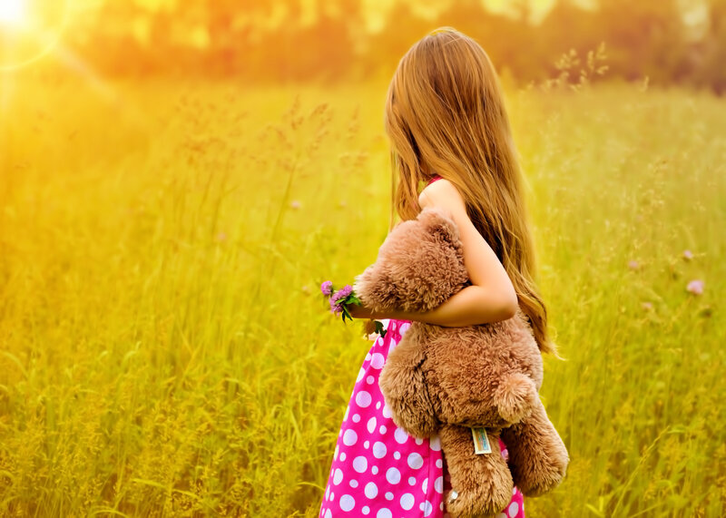 Girl Holding Teddy Bear — Yellow