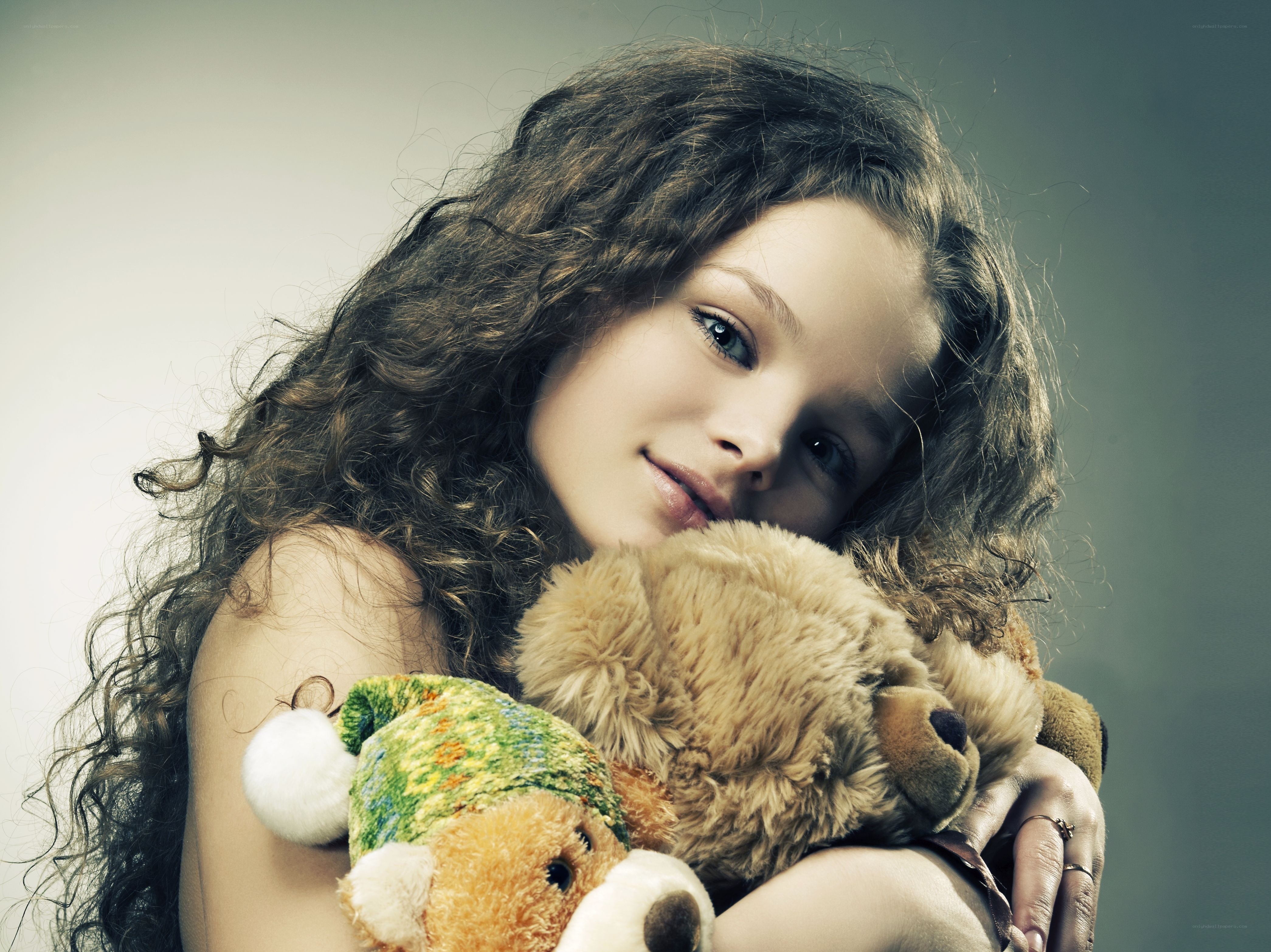 girl holding teddy bears