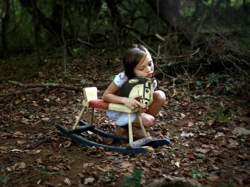 Girl Holding Toy Horse
