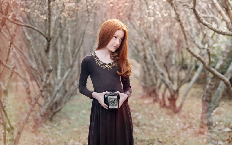Girl holding vintage camera