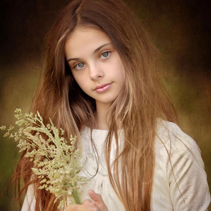 Girl Holding Wildflowers — Brown