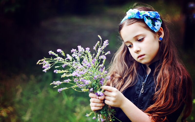 girl holding wildflowers