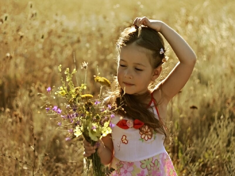 Girl Holding Wildflowers — Yellow