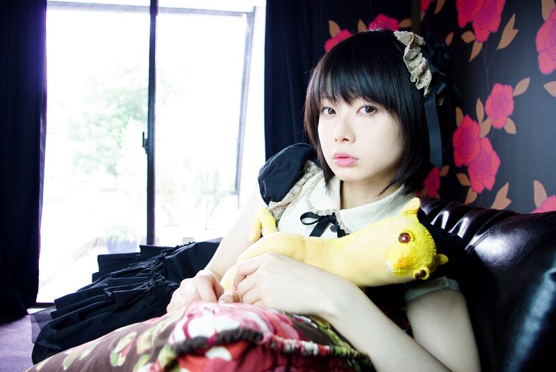 girl holding yellow plush toy
