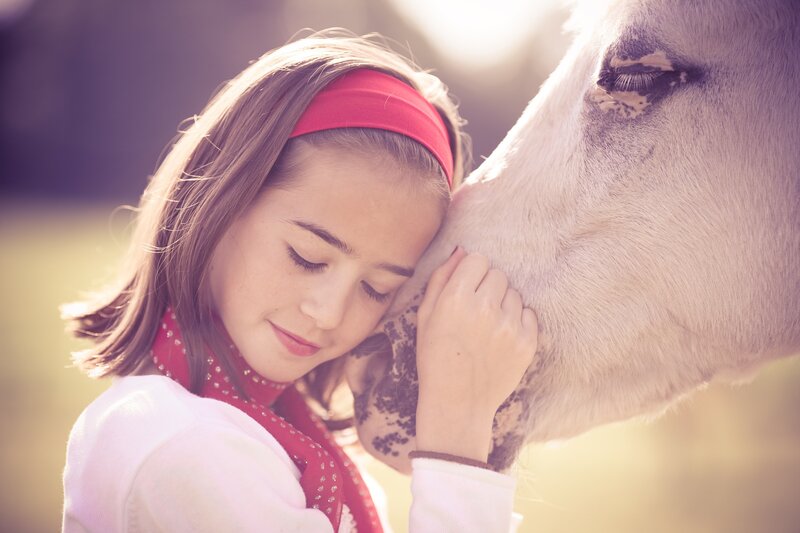 girl hugging a horse
