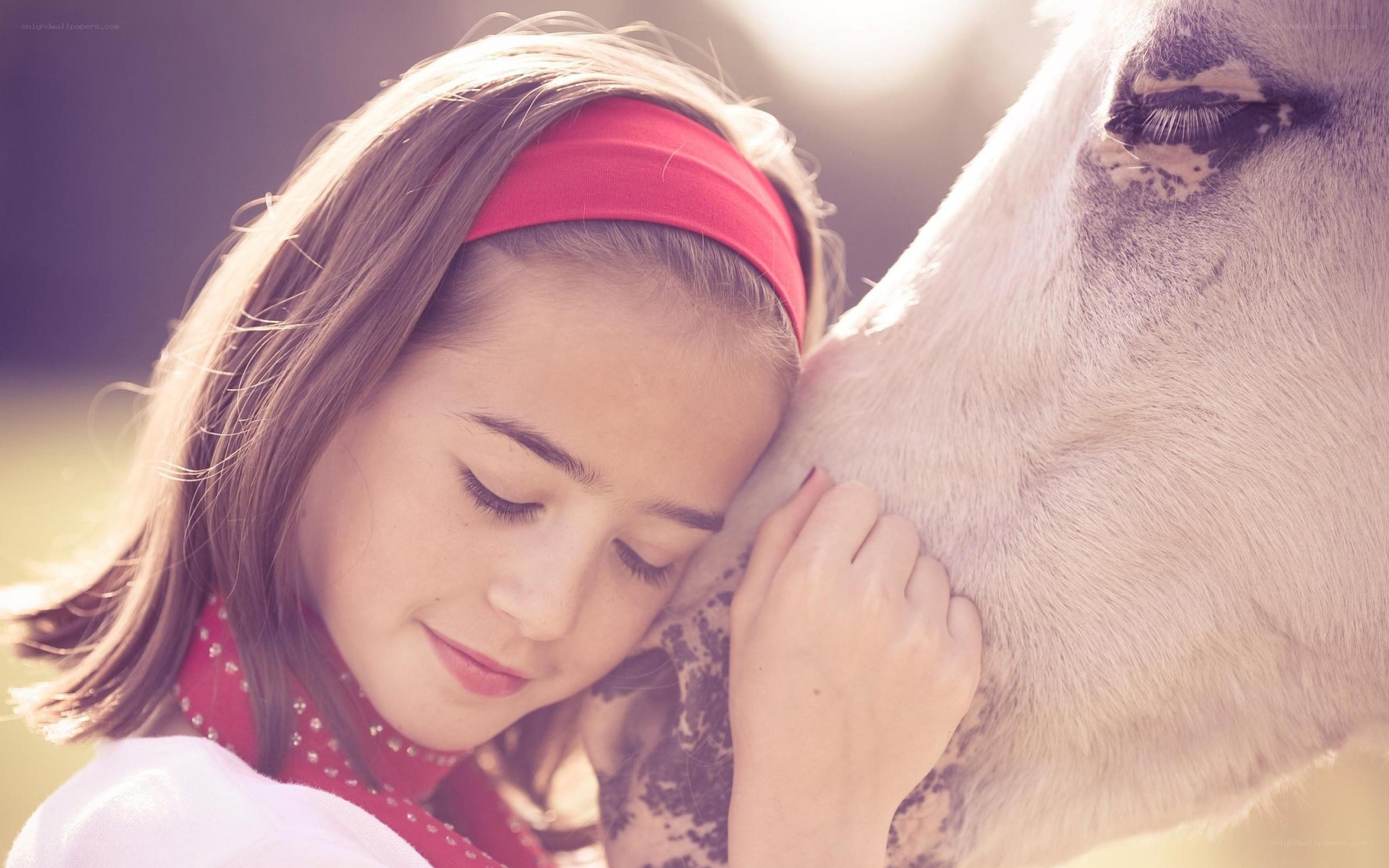 girl hugging a horse