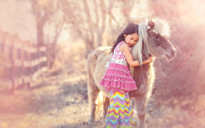 Girl Hugging a Pony