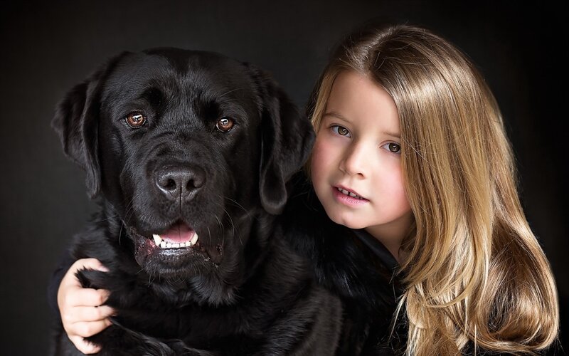 Girl Hugging Black Dog — Calm