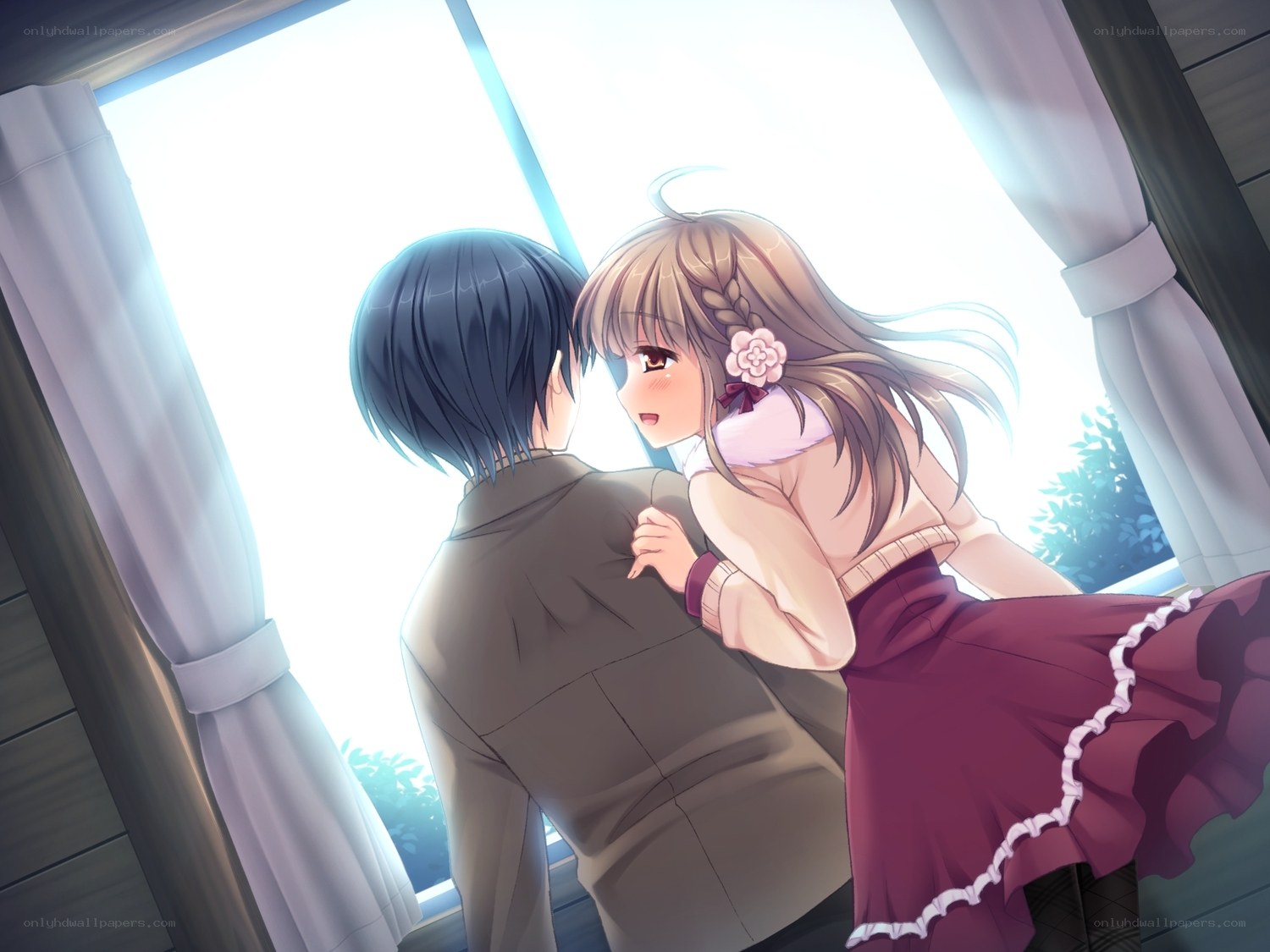 girl hugging boy by window