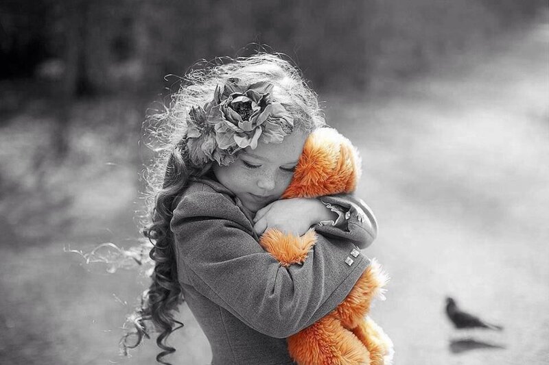 Girl Hugging Stuffed Animal