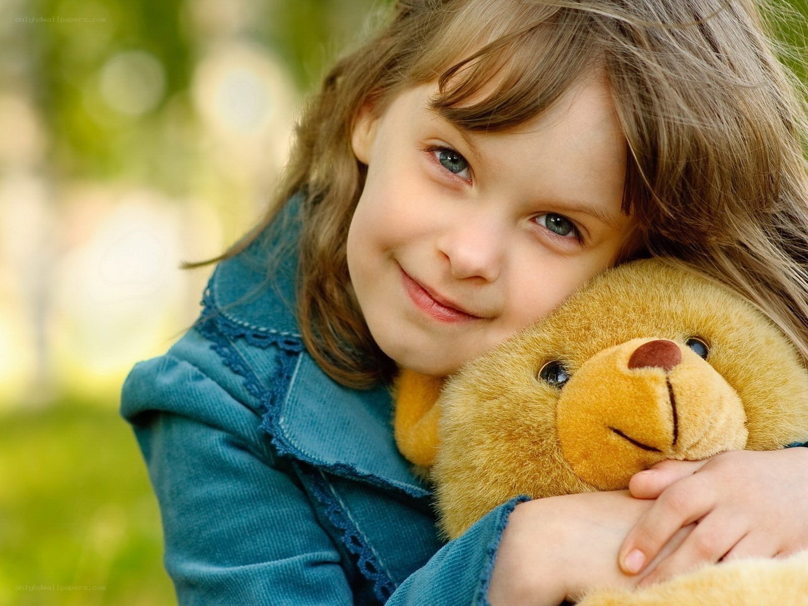 girl hugging teddy bear