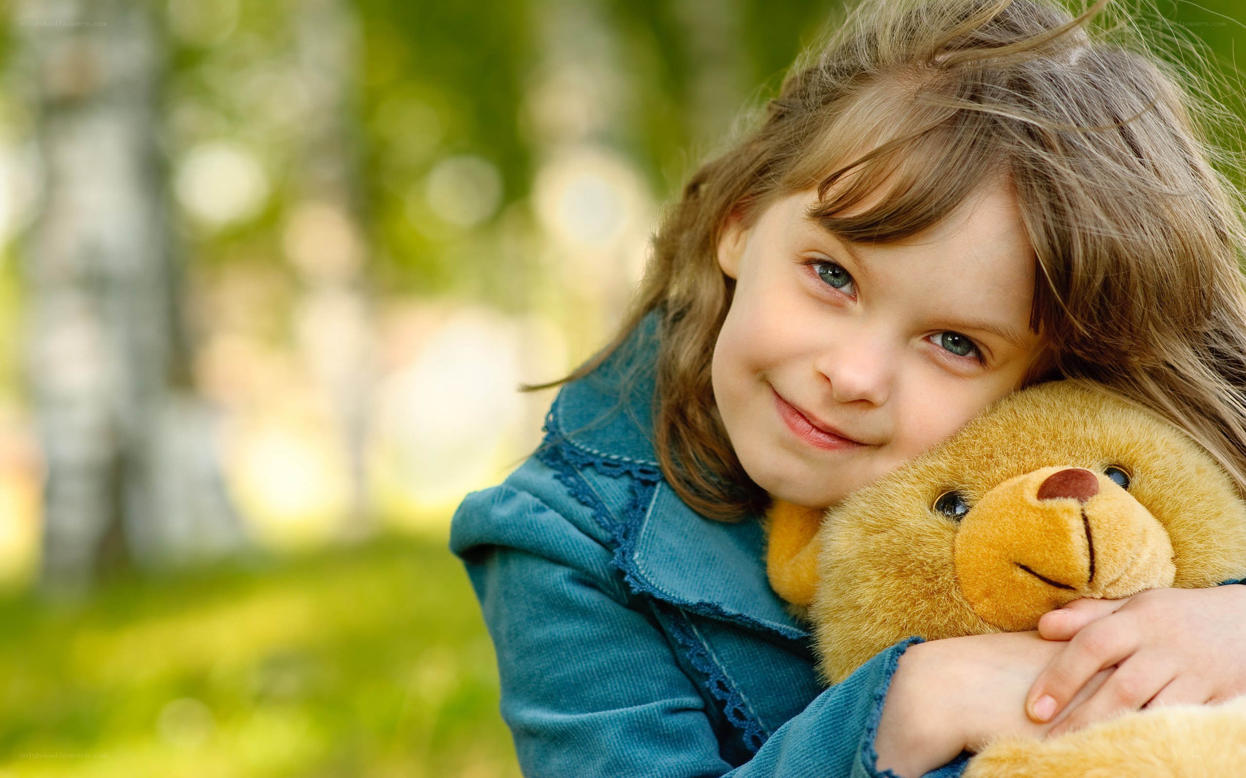 girl hugging teddy bear