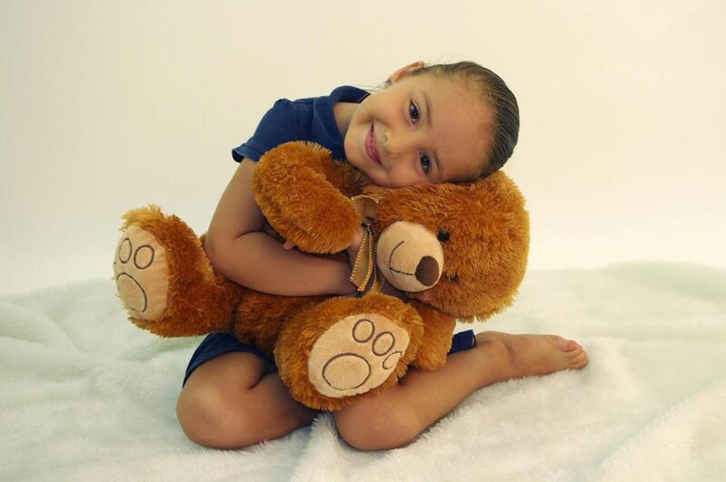 Girl Hugging Teddy Bear — Brown