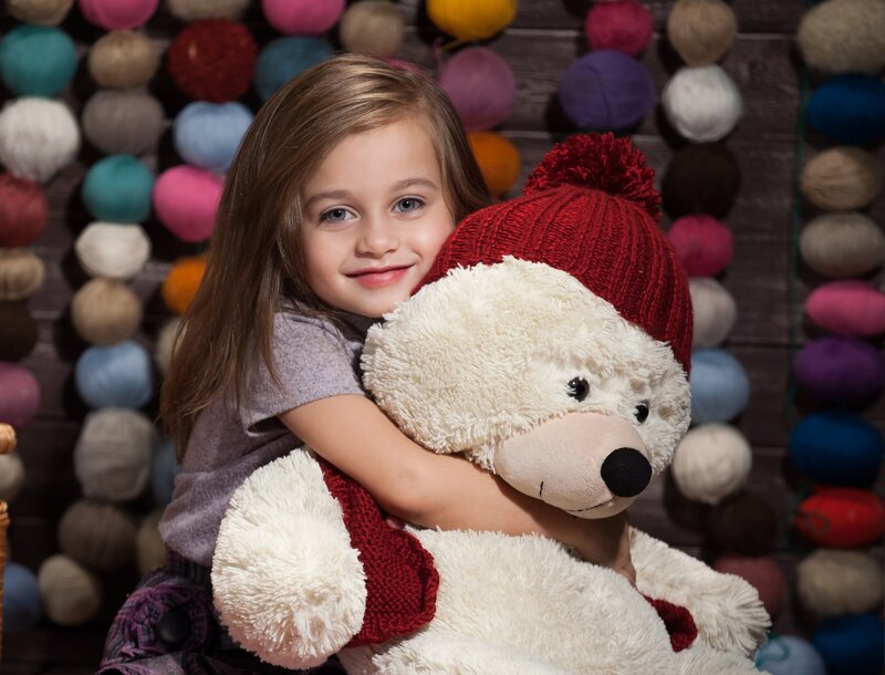 Girl Hugging Teddy Bear — White, Happy