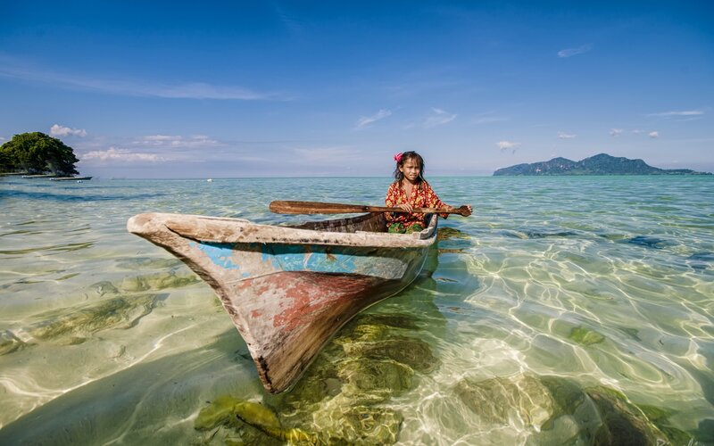 Girl in a boat on clear water