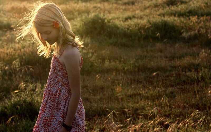 girl in a field at sunset