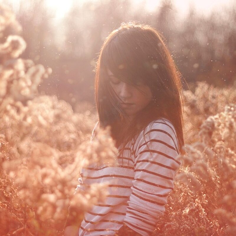 girl in a field at sunset