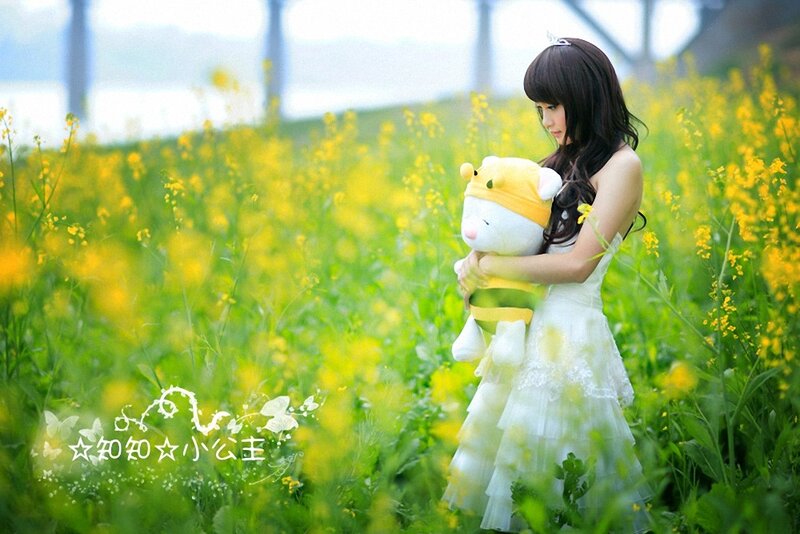 Girl in a field with a stuffed animal