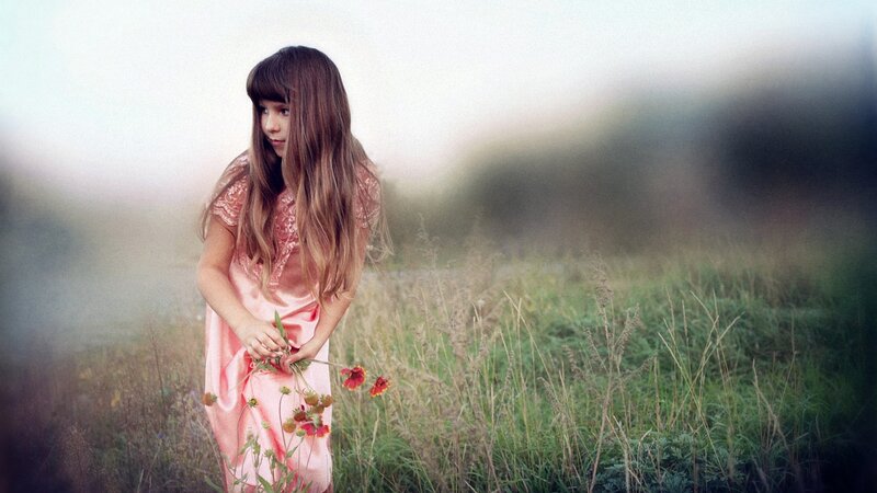 Girl in a field with flowers