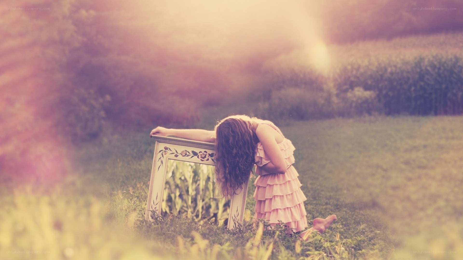 Girl in a field with mirror
