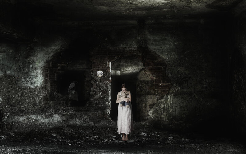 Girl in a ruined basement