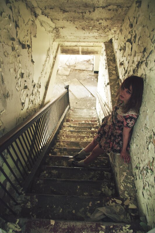 Girl in abandoned stairwell