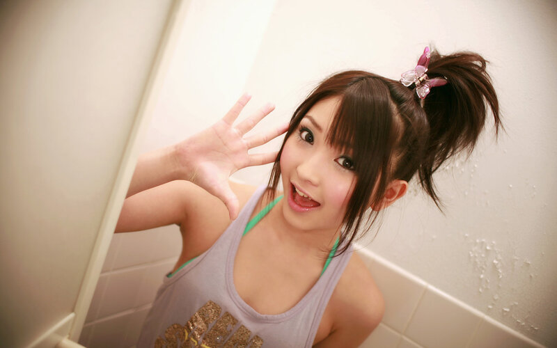 girl in bathroom waving