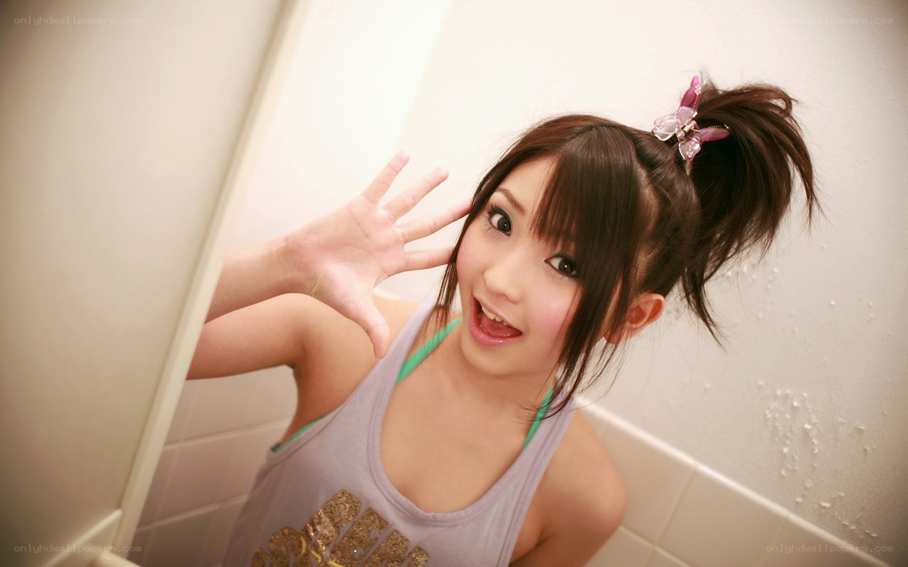 girl in bathroom waving