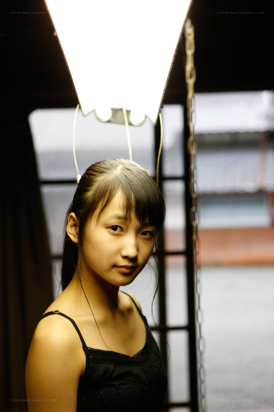 girl in black top under light