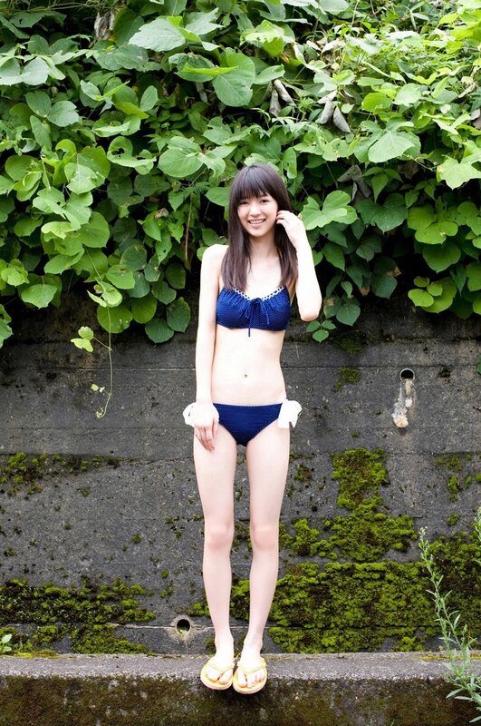 Girl in blue bikini smiling