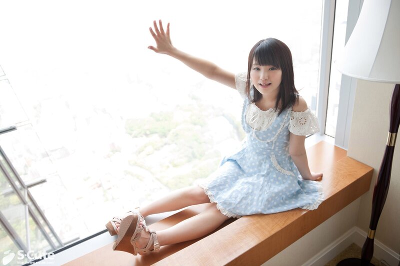 girl in blue dress by window