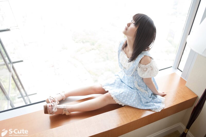 Girl in blue dress by window