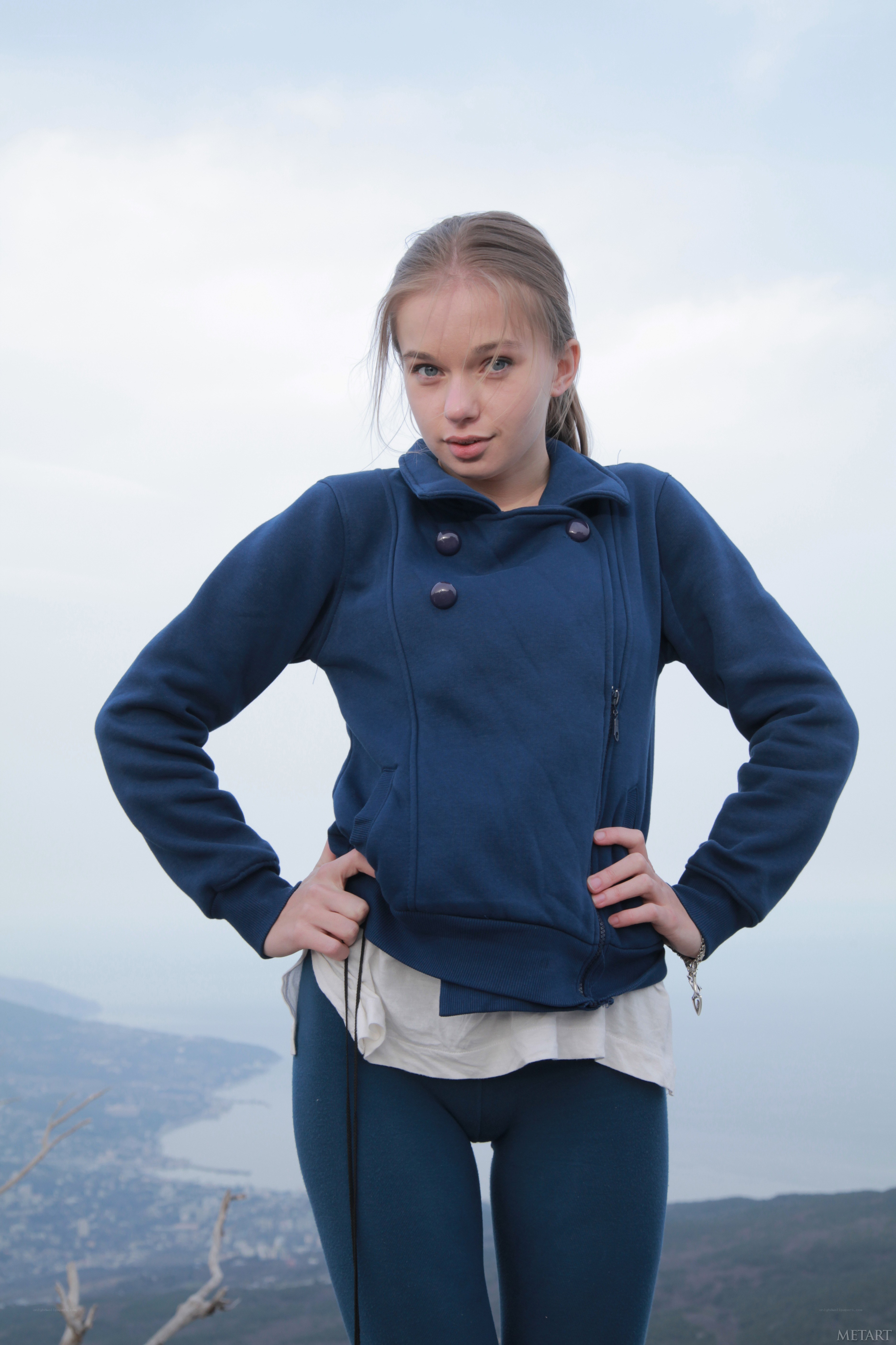 girl in blue jacket on hill