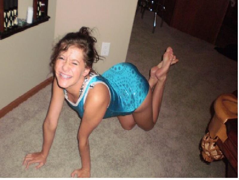 girl in blue leotard on floor