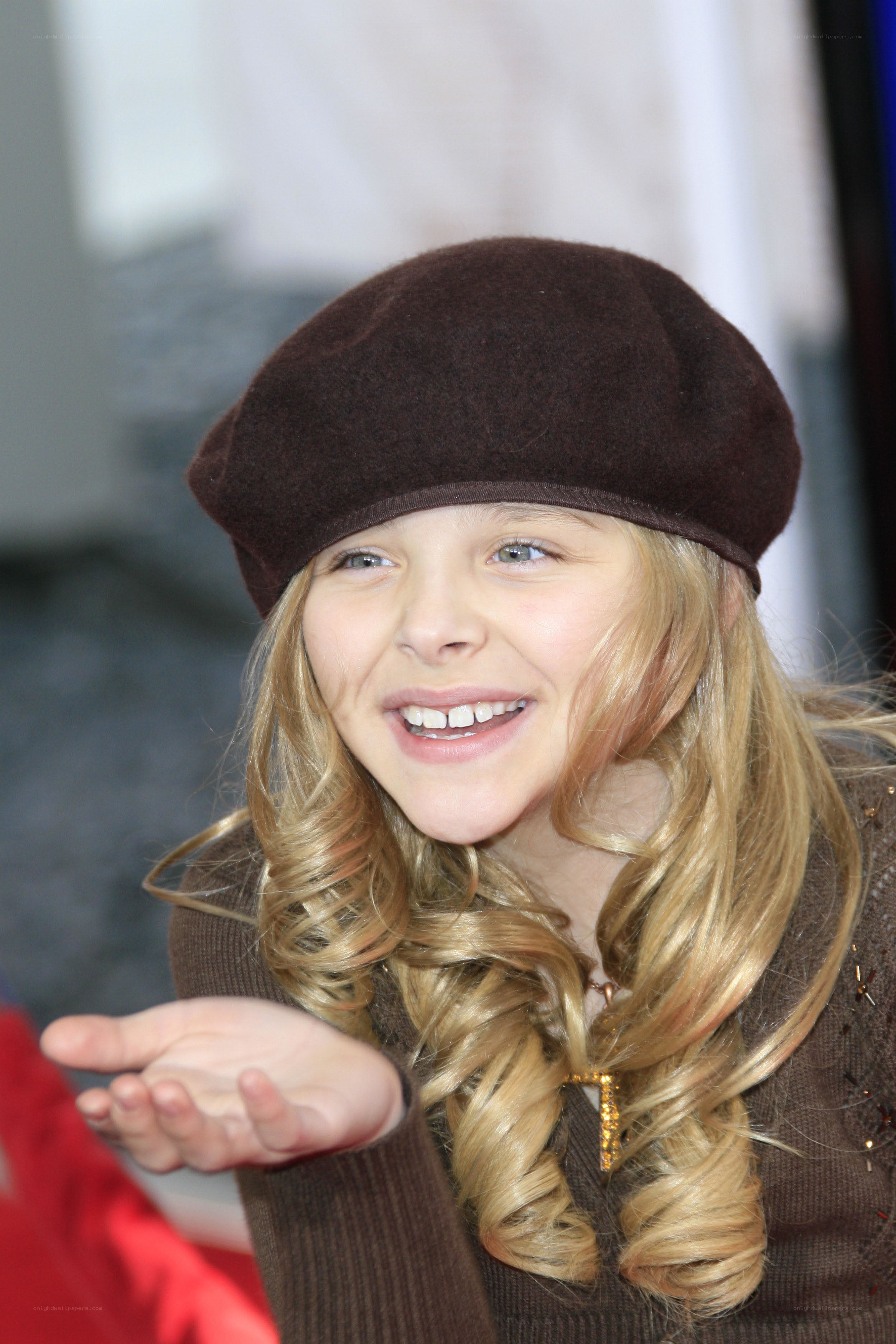 girl in brown beret smiling