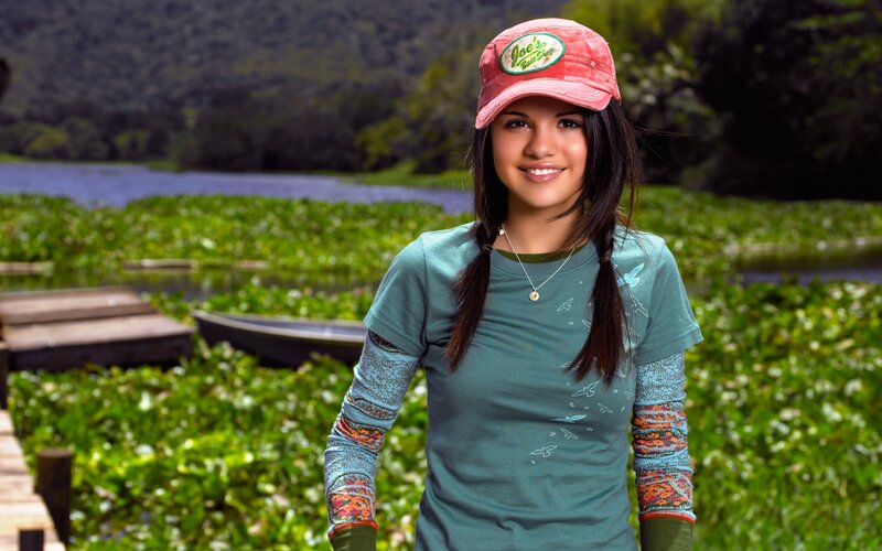 girl in cap by a lake
