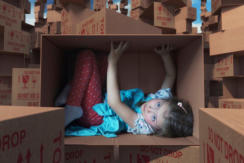 Girl in Cardboard Box