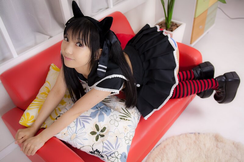 girl in cat ears on red couch