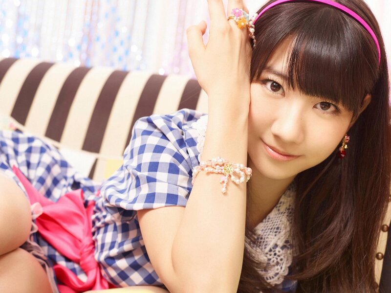 girl in checkered dress smiling