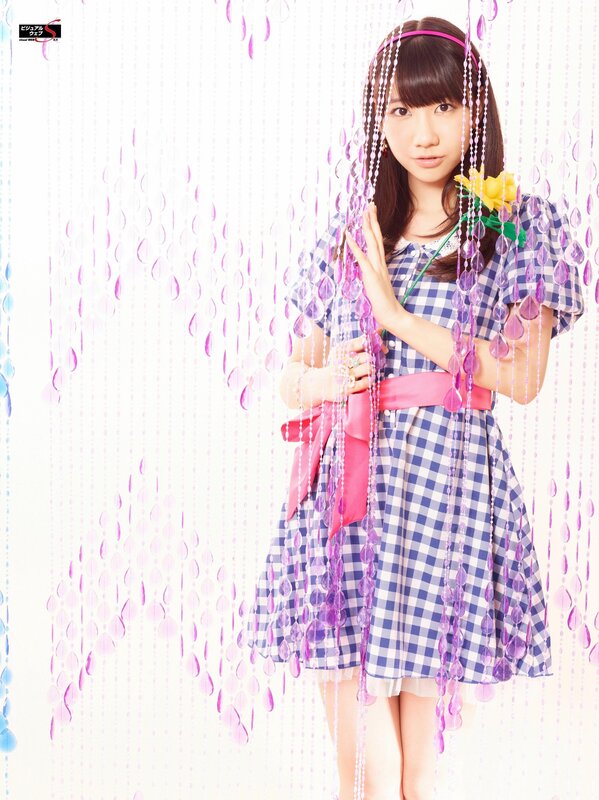 Girl in checkered dress with beads