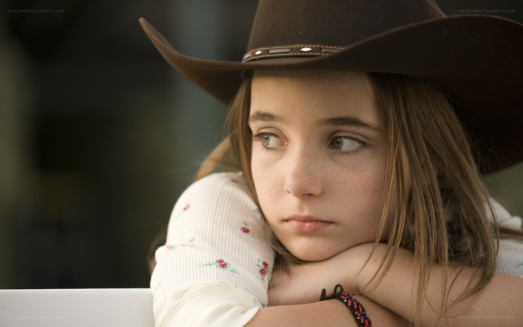 girl in cowboy hat resting