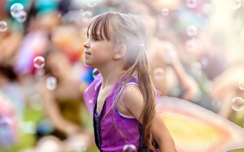 Girl in fairy costume with bubbles