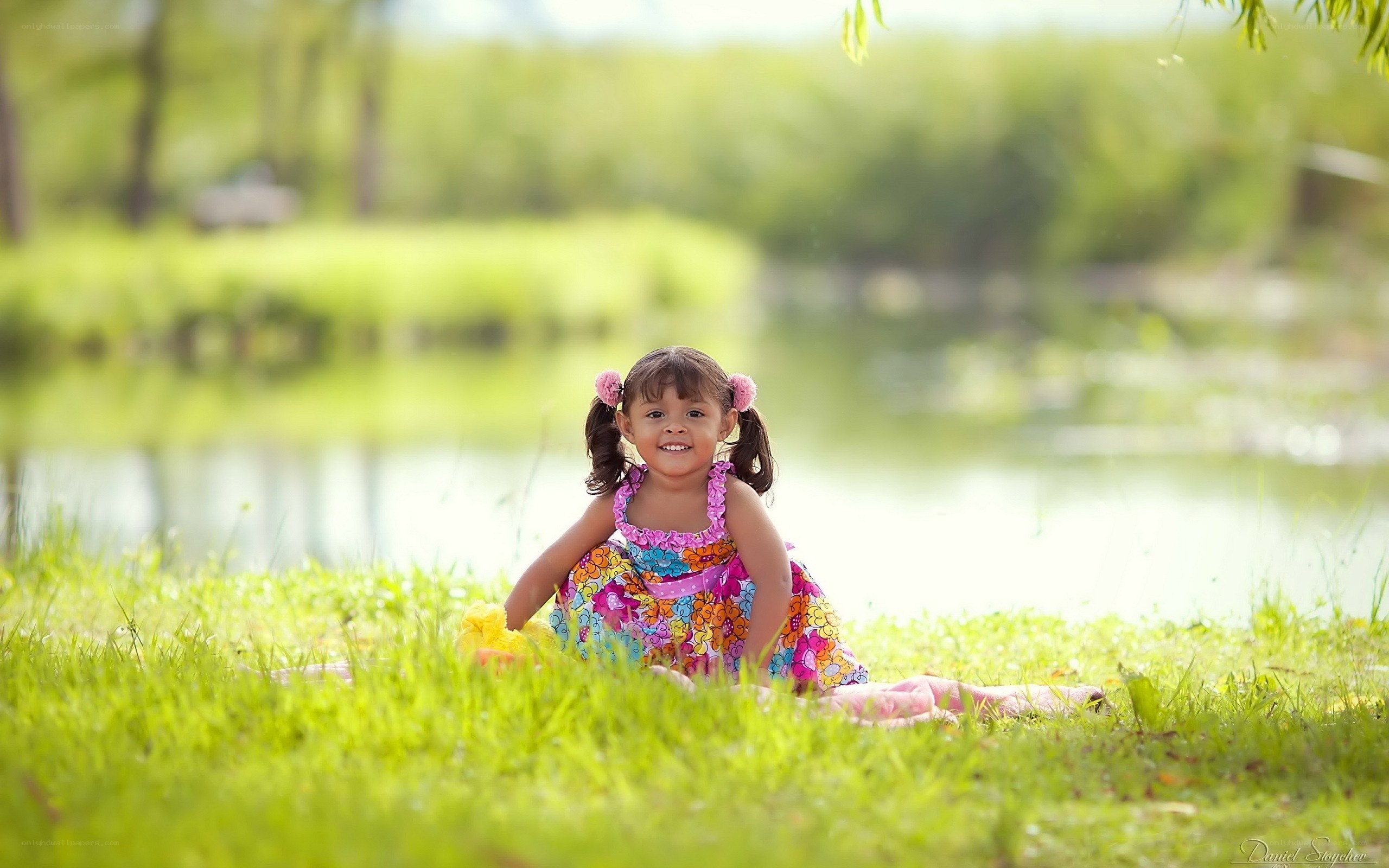 Girl in floral dress by pond