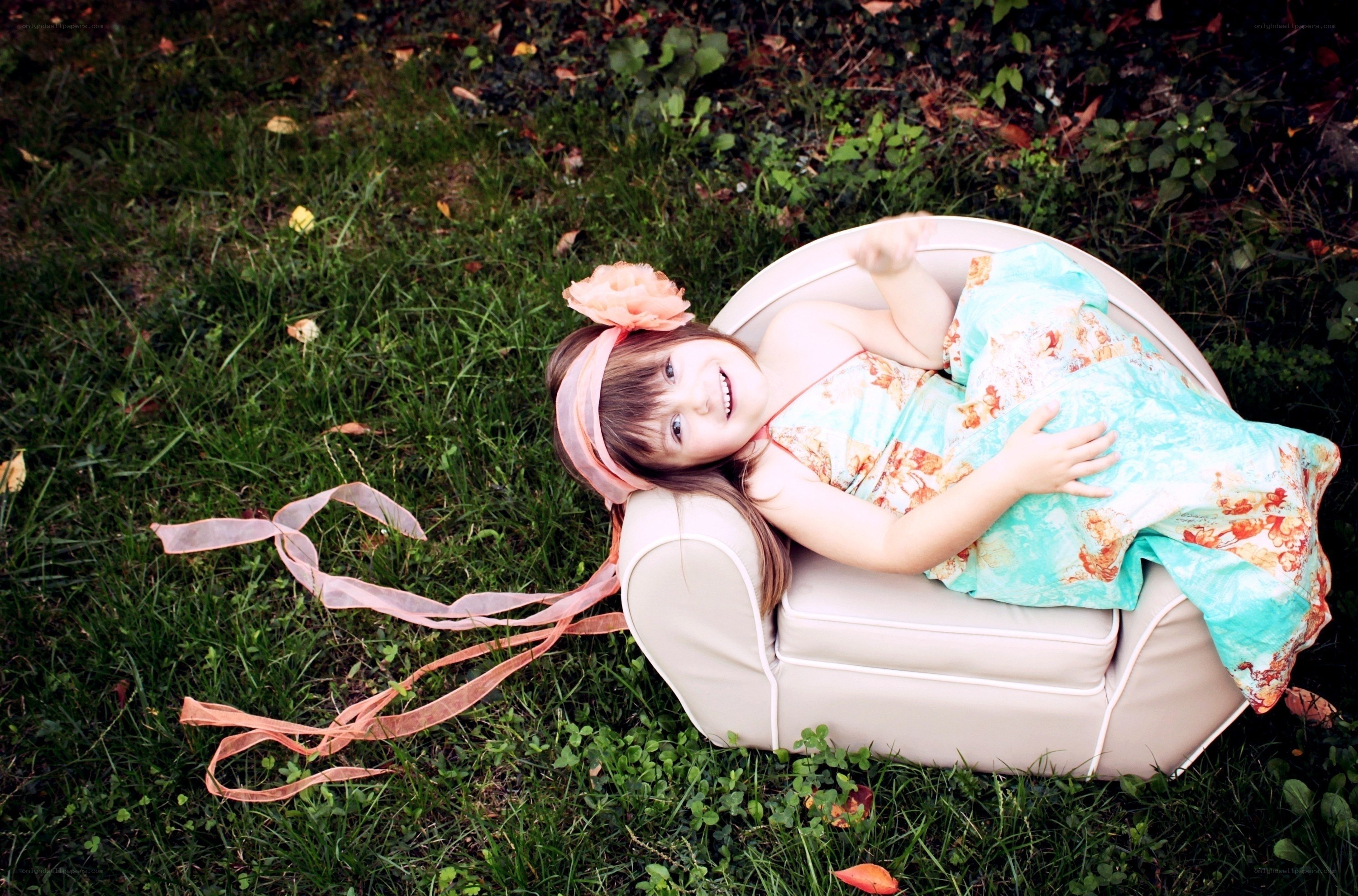 girl in floral dress on chair
