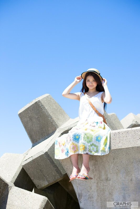 Girl in floral dress on concrete blocks