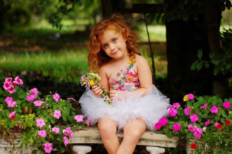 Girl in floral dress with flowers