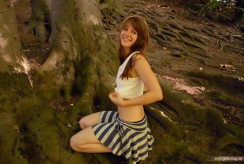 Girl in forest near tree