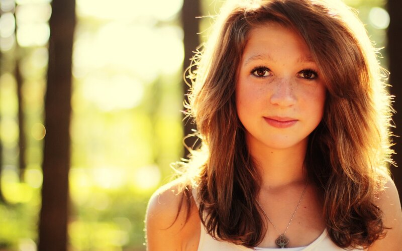 girl in forest sunlight